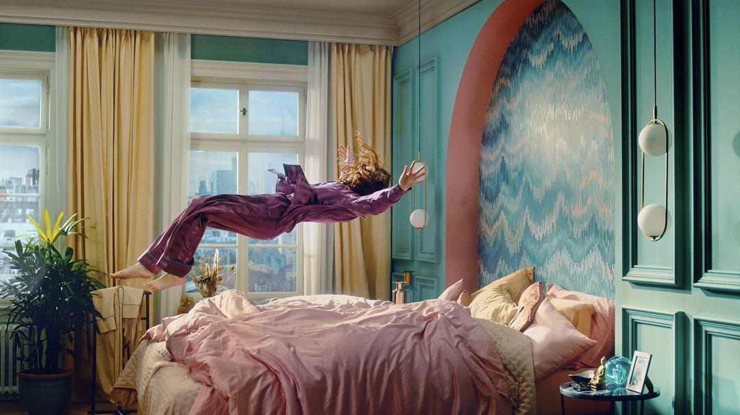 Osoba padající na postel